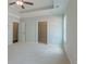Bedroom featuring plush carpet, neutral paint, a tray ceiling, a ceiling fan and walk in closet at 490 Benson Meadows Dr, Dallas, GA 30157