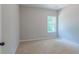 This bedroom features neutral carpet and a window with natural lighting creating a serene space at 490 Benson Meadows Dr, Dallas, GA 30157
