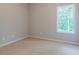 This bedroom features neutral carpet and a window with natural lighting creating a serene space at 490 Benson Meadows Dr, Dallas, GA 30157