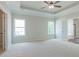 Main bedroom featuring a tray ceiling, two windows, plush carpeting, and neutral paint at 490 Benson Meadows Dr, Dallas, GA 30157
