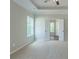 Bedroom featuring plush carpet, neutral paint, a tray ceiling, and two bright windows at 490 Benson Meadows Dr, Dallas, GA 30157