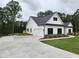New construction home featuring white siding, a spacious driveway, and an attached two-car garage at 490 Benson Meadows Dr, Dallas, GA 30157