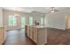 Open-concept kitchen boasts large island with sink, granite counters, and stainless steel faucet at 490 Benson Meadows Dr, Dallas, GA 30157