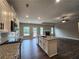 Modern kitchen with a granite countertop island, hardwood floors, and stainless steel appliances at 490 Benson Meadows Dr, Dallas, GA 30157