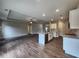 Open-concept space with modern kitchen, granite counters, stainless appliances, and hardwood floors at 490 Benson Meadows Dr, Dallas, GA 30157