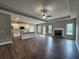 Spacious living area featuring an open-concept kitchen, fireplace, and hardwood floors at 490 Benson Meadows Dr, Dallas, GA 30157