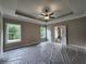 Spacious main bedroom with tray ceiling, ceiling fan, and ensuite bathroom access at 490 Benson Meadows Dr, Dallas, GA 30157