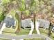 Aerial view showcasing three houses with manicured lawns, complemented by well-maintained landscaping at 305 Red Gate Ln, Canton, GA 30115