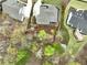 Aerial view showcasing a backyard with mature trees and fenced perimeter, offering privacy and space at 305 Red Gate Ln, Canton, GA 30115