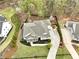 Aerial view highlights home's curb appeal with well-maintained landscaping and a long driveway at 305 Red Gate Ln, Canton, GA 30115