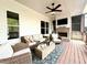 A comfortable outdoor living space featuring ceiling fans, nice furniture, and a cozy fireplace at 305 Red Gate Ln, Canton, GA 30115