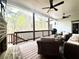 A comfortable outdoor living space featuring ceiling fans, nice furniture, and a cozy fireplace at 305 Red Gate Ln, Canton, GA 30115