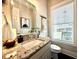 Well-lit half bath with granite countertop, modern fixtures, and a decorative mirror at 305 Red Gate Ln, Canton, GA 30115