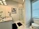 Bathroom featuring a granite countertop, glass shower, and modern fixtures at 305 Red Gate Ln, Canton, GA 30115