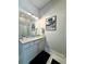 Well-lit bathroom with modern vanity and glass enclosed shower at 305 Red Gate Ln, Canton, GA 30115