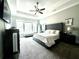 Beautiful bedroom featuring carpet, a ceiling fan, and a large bed with a tufted headboard at 305 Red Gate Ln, Canton, GA 30115