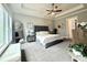 Spacious bedroom with tray ceilings, large windows, and a seating area to enjoy the outdoor view at 305 Red Gate Ln, Canton, GA 30115