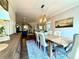 Open-concept dining area with hardwood floors, view to other living area, and a modern chandelier at 305 Red Gate Ln, Canton, GA 30115