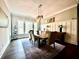 Charming dining room with hardwood floors, natural light, and a modern chandelier at 305 Red Gate Ln, Canton, GA 30115