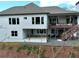 Rear view of the home featuring a deck, patio, and modern design elements at 305 Red Gate Ln, Canton, GA 30115