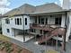 Rear of the home featuring outdoor living spaces with a deck, patio, and modern aesthetic at 305 Red Gate Ln, Canton, GA 30115
