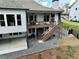 Exterior back of home with a deck, patio, and landscaped backyard at 305 Red Gate Ln, Canton, GA 30115