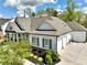 Craftsman-style home with a three car garage and landscaped front yard at 305 Red Gate Ln, Canton, GA 30115