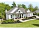 Beautiful craftsman-style home featuring a landscaped yard, and a welcoming front porch at 305 Red Gate Ln, Canton, GA 30115