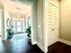 A bright and inviting foyer with a decorative rug, elegant lighting, and hardwood flooring at 305 Red Gate Ln, Canton, GA 30115