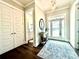 A bright and inviting foyer with a decorative rug, elegant lighting, and access to a bathroom at 305 Red Gate Ln, Canton, GA 30115