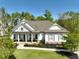 Beautiful craftsman-style home featuring a welcoming front porch, and a manicured front yard at 305 Red Gate Ln, Canton, GA 30115