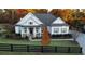 Craftsman-style home with inviting front porch and well-manicured lawn, enhanced by fall foliage at 305 Red Gate Ln, Canton, GA 30115