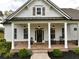 Charming front porch with brick flooring and classic rocking chairs, offers a relaxing outdoor space at 305 Red Gate Ln, Canton, GA 30115