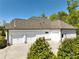 Exterior view of a three car garage featuring a large concrete driveway at 305 Red Gate Ln, Canton, GA 30115