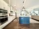 Modern kitchen with stainless steel appliances and a large island with barstool seating, perfect for casual dining at 305 Red Gate Ln, Canton, GA 30115