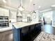 Bright kitchen with an island, stainless steel appliances, and granite countertops, perfect for cooking and entertaining at 305 Red Gate Ln, Canton, GA 30115