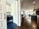 Open view of laundry room with appliances, next to an open view of the kitchen and living space at 305 Red Gate Ln, Canton, GA 30115