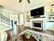 Bright living room features a fireplace, built-in shelving, and hardwood floors at 305 Red Gate Ln, Canton, GA 30115