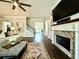 Inviting living room showcasing a brick fireplace, built-in shelving, and elegant hardwood floors at 305 Red Gate Ln, Canton, GA 30115