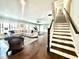 Inviting living area featuring hardwood floors, a staircase, and comfortable seating arrangement at 305 Red Gate Ln, Canton, GA 30115