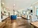 Bright open living space features hardwood floors, a kitchen island, a comfortable sofa, and access to the outdoors at 305 Red Gate Ln, Canton, GA 30115