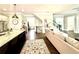 Open-concept living space with a kitchen island, hardwood floors, and staircase at 305 Red Gate Ln, Canton, GA 30115