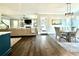 Open-concept living space with hardwood floors, a cozy sofa, and a dining area filled with natural light at 305 Red Gate Ln, Canton, GA 30115
