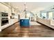 Bright open living space features hardwood floors, a kitchen island, a comfortable sofa, and access to the outdoors at 305 Red Gate Ln, Canton, GA 30115