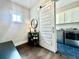 View of mudroom with bench and shelving adjacent to the laundry room with modern appliances at 305 Red Gate Ln, Canton, GA 30115