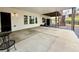 Large covered patio with an outdoor seating area, access to the backyard, and concrete flooring at 305 Red Gate Ln, Canton, GA 30115