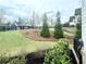 Expansive yard features lush greenery, framed by a classic black fence adding a touch of elegance at 305 Red Gate Ln, Canton, GA 30115