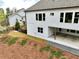 The backyard is landscaped, partially fenced, and features a small patio at 305 Red Gate Ln, Canton, GA 30115