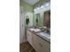 Bathroom featuring double sinks, granite countertops, and modern fixtures at 3440 Camelot Way, Loganville, GA 30052