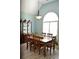 Bright dining room featuring a wooden table and chairs with a cabinet and window at 3440 Camelot Way, Loganville, GA 30052
